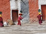 Mustang Lo Manthang 03 01 Chyodi Gompa Young Monks On my third morning in Lo Manthang I visited the courtyard of the Chyodi gompa. I saw a few young monks wearing the Tiji Festival plume hats heading for the Chyodi Gompa in Lo Manthang.